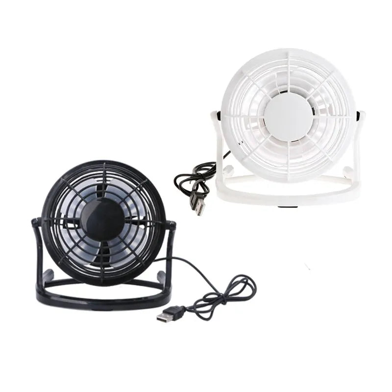 Mini USB desk fan with adjustable angle in black colour beside laptop