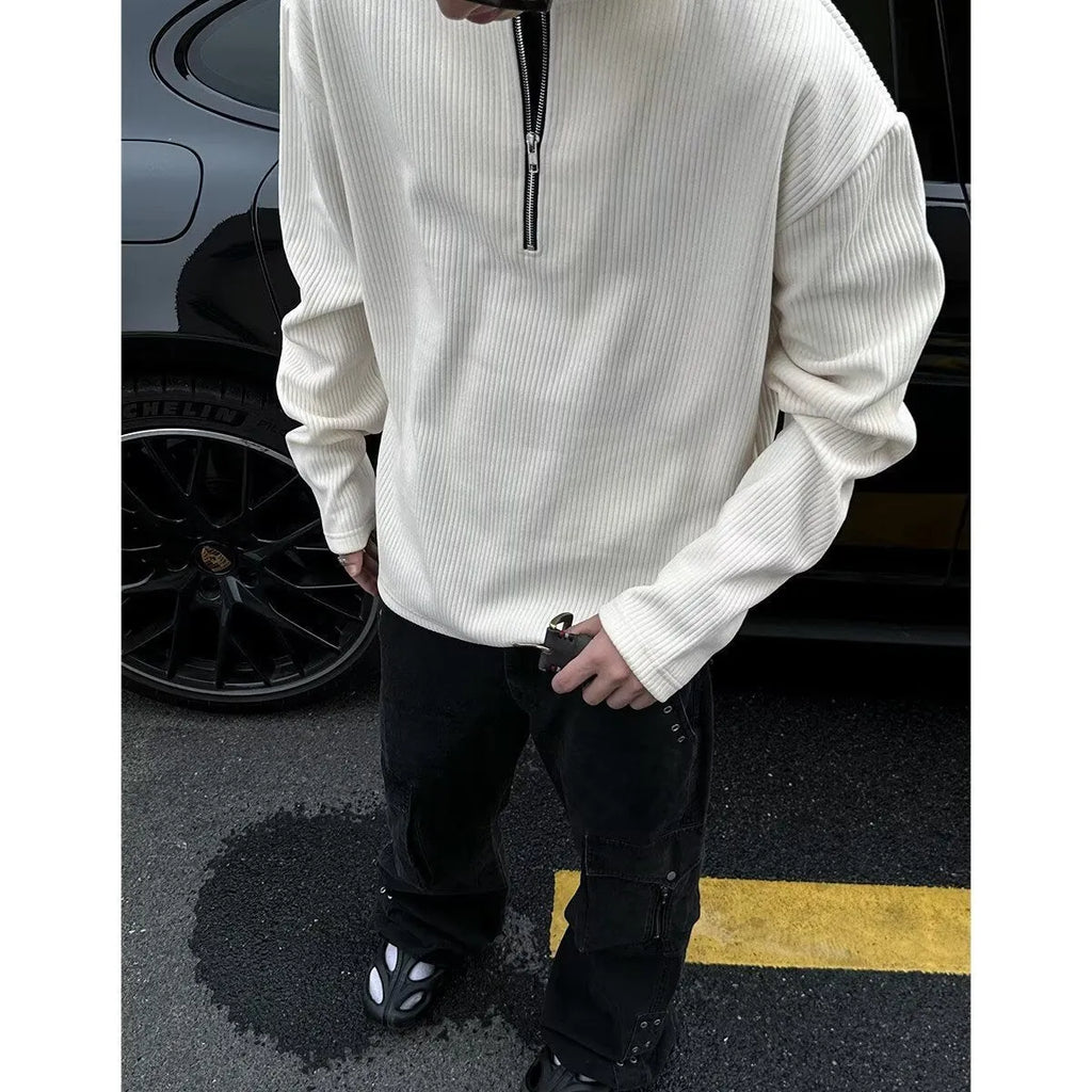 A solid colour loose pullover top with long sleeves, shown in apricot, grey and black.