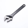 A black high carbon steel adjustable wrench on a white background, showing its open jaws and knurled adjustment screw.