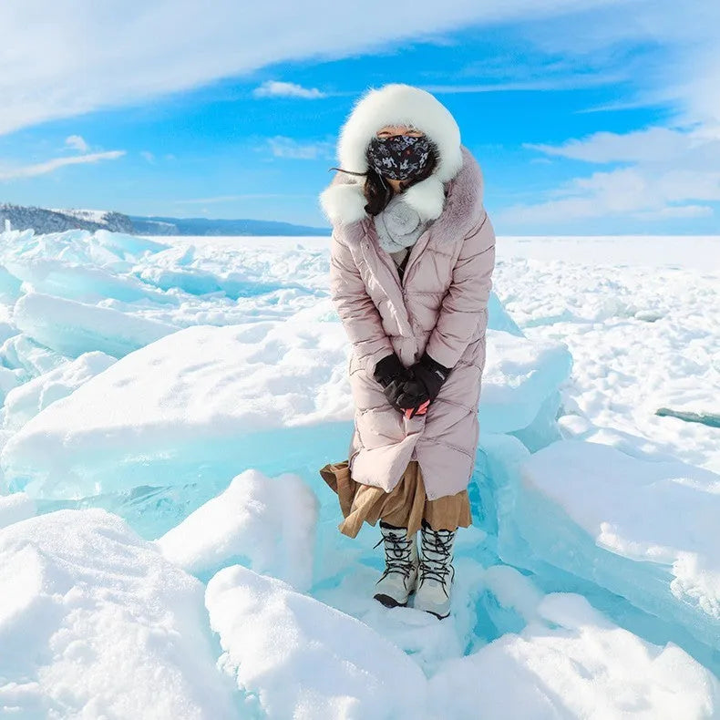 Women's white genuine leather mid-calf snow boots with a round toe and rubber sole on a plain background.