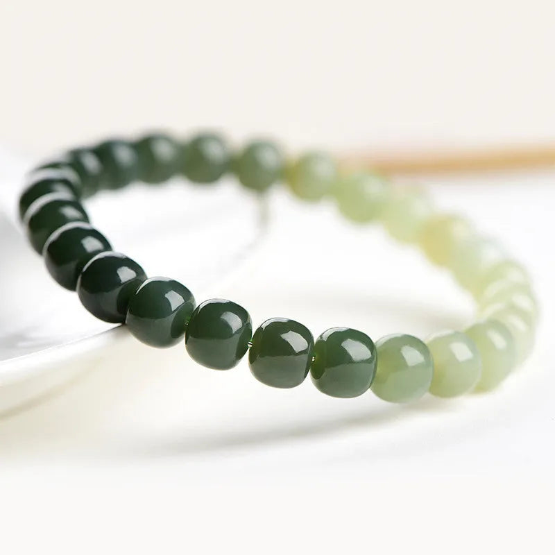 Hetian Jade bracelet with water gradient colours showing polished beads in natural stone