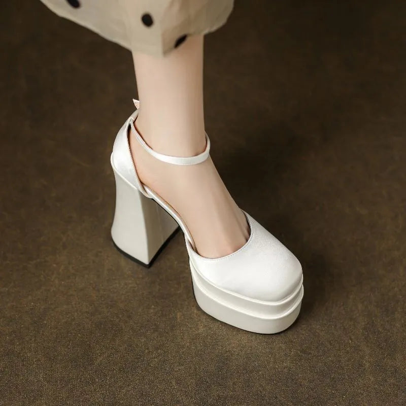 Women's white platform high heels with a chunky heel and round toe.