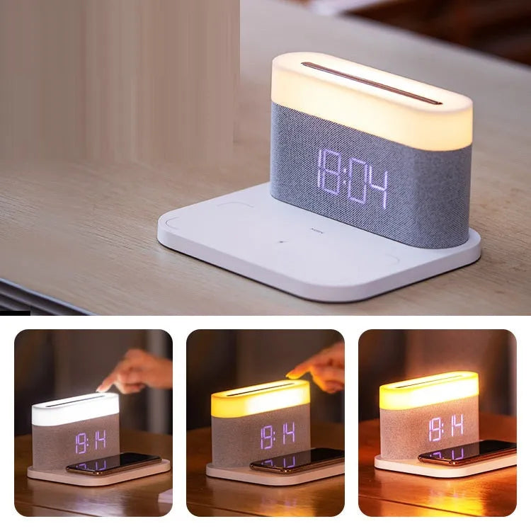 White bedside table lamp with integrated digital clock and wireless phone charging pad on base.
