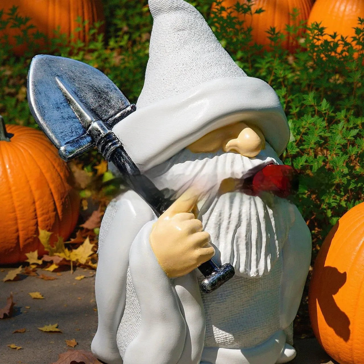 Christmas resin ornament of a dwarf holding a smoking shovel for garden and table decoration