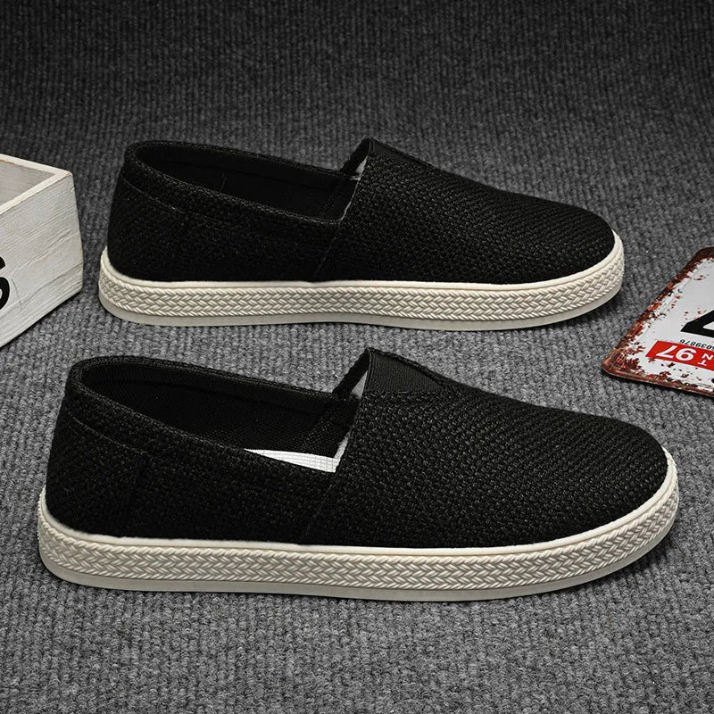Men's beige linen cloth canvas shoes with round toe and shallow cut on a plain background