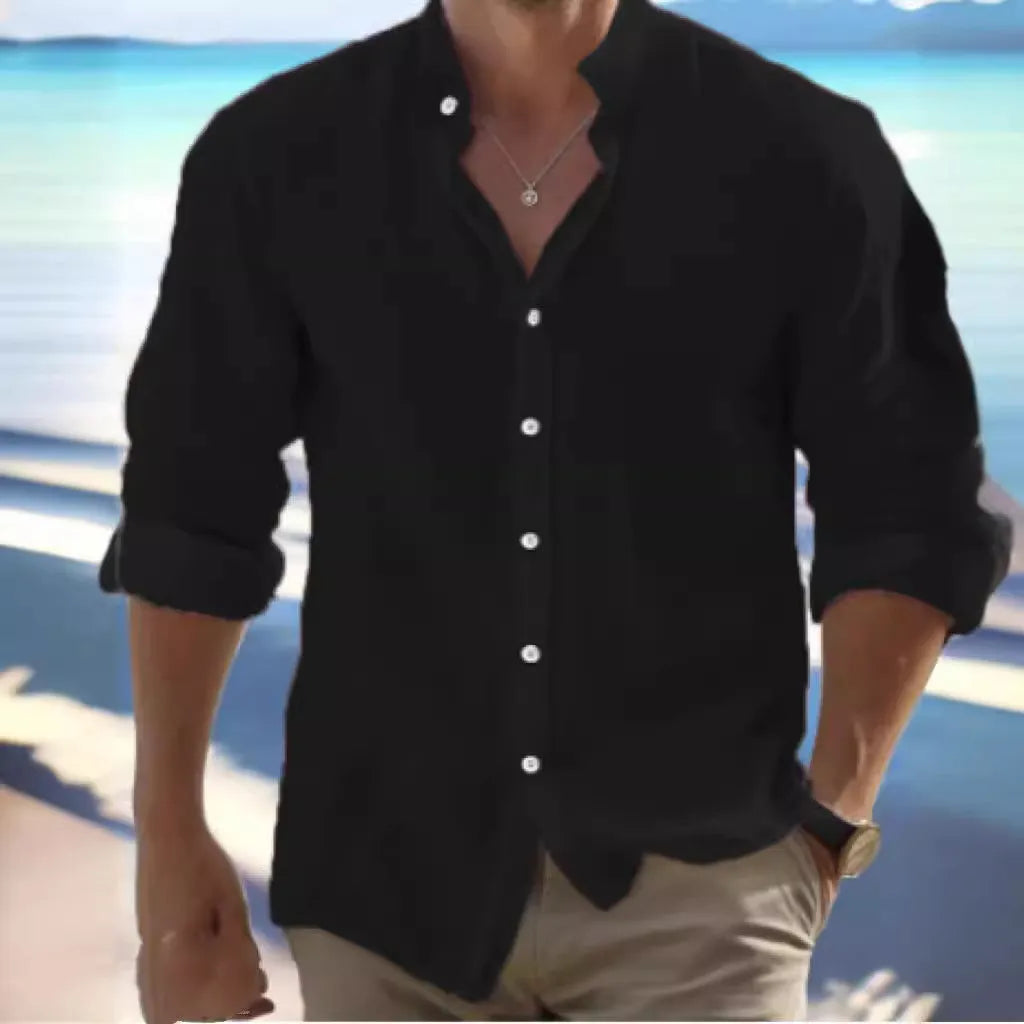 Man wearing a light blue long-staple cotton button-down beach shirt, casual summer style.