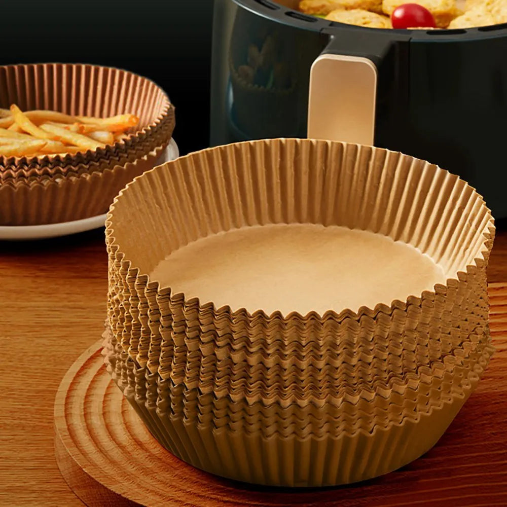 Round white disposable parchment paper liner for air fryer basket with raised edges.