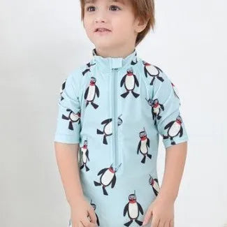 Boys' blue penguin print swim set with long sleeve swimsuit and matching swimming cap