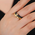 Glossy titanium steel women's ring with zirconium inlay in a heart shape on a double band.