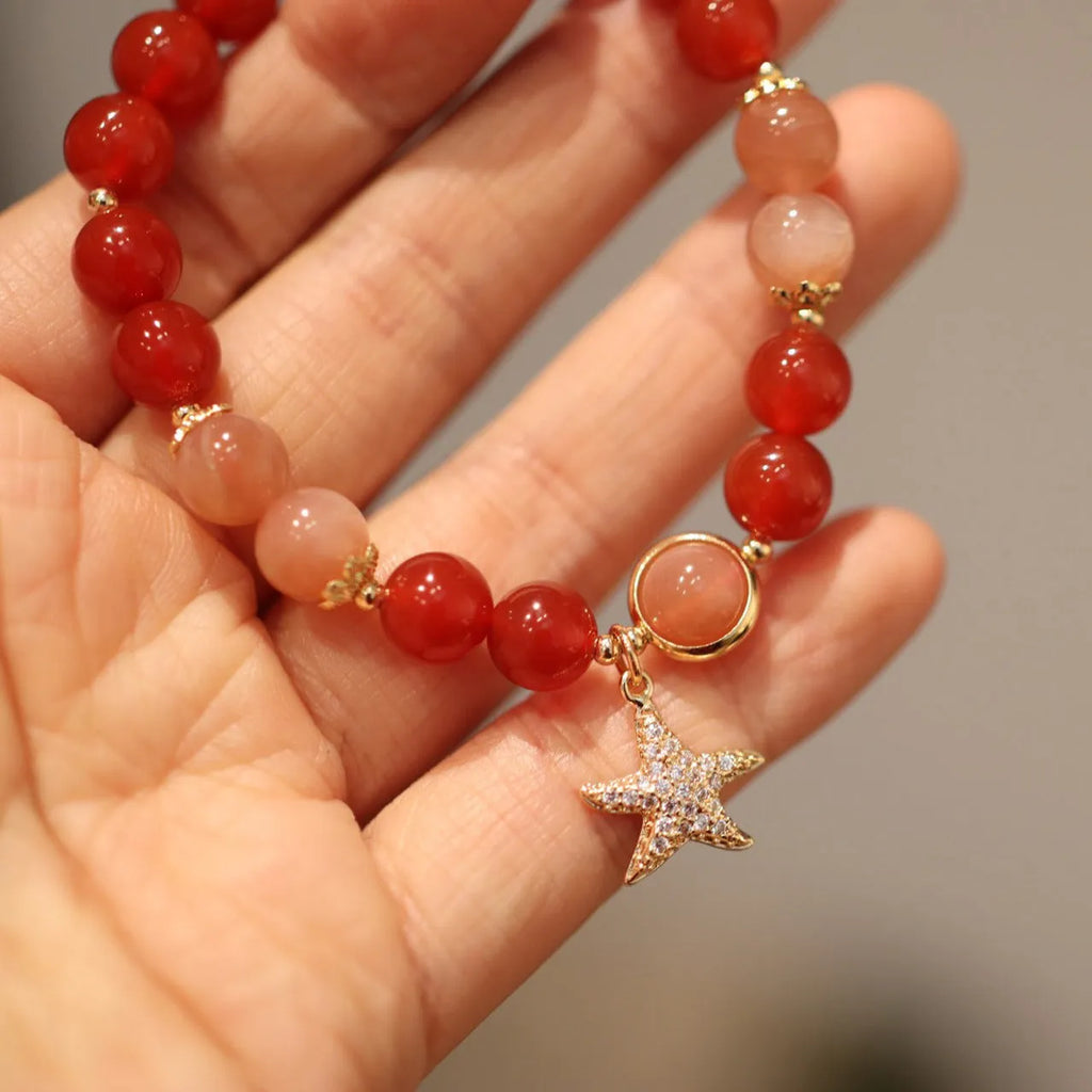 Handmade ethnic-style bracelet with sand orange Sunstone and 8mm red agate beads in a star pattern.