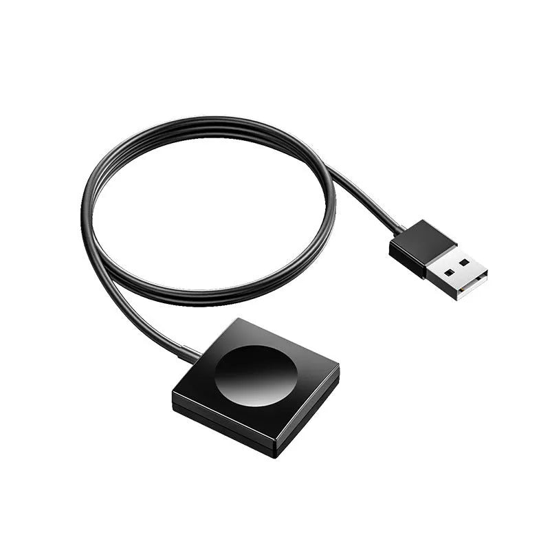 Portable white wireless charging dock for Apple Watch on a desk next to a laptop.