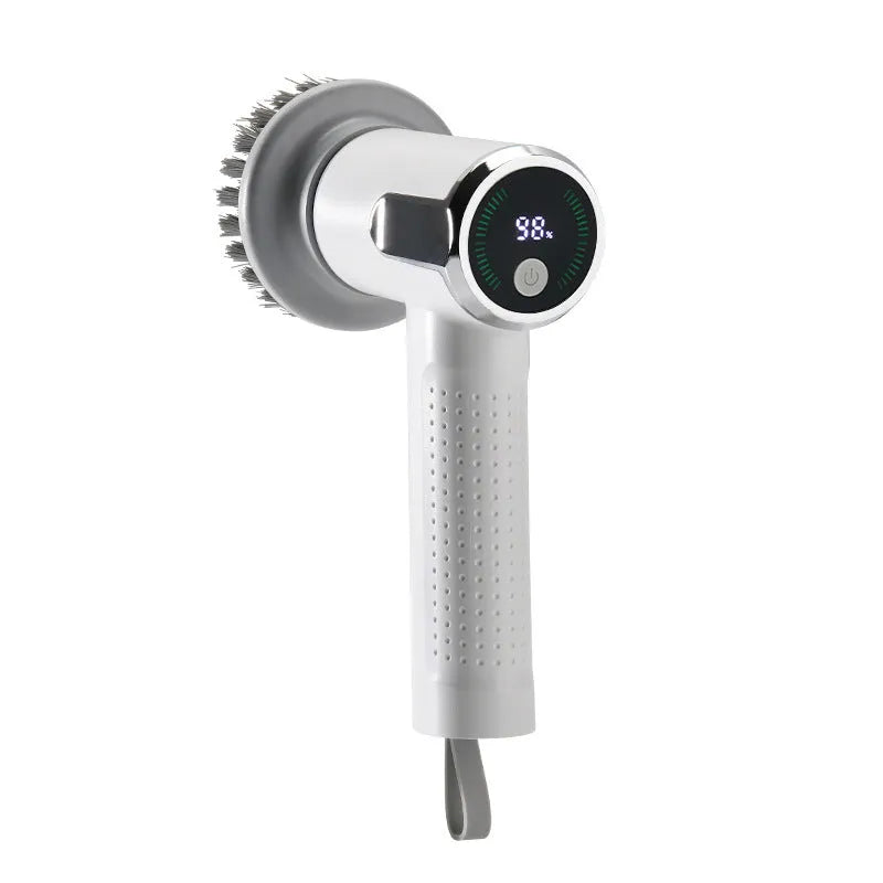 White cordless electric cleaning brush with interchangeable heads on a kitchen counter