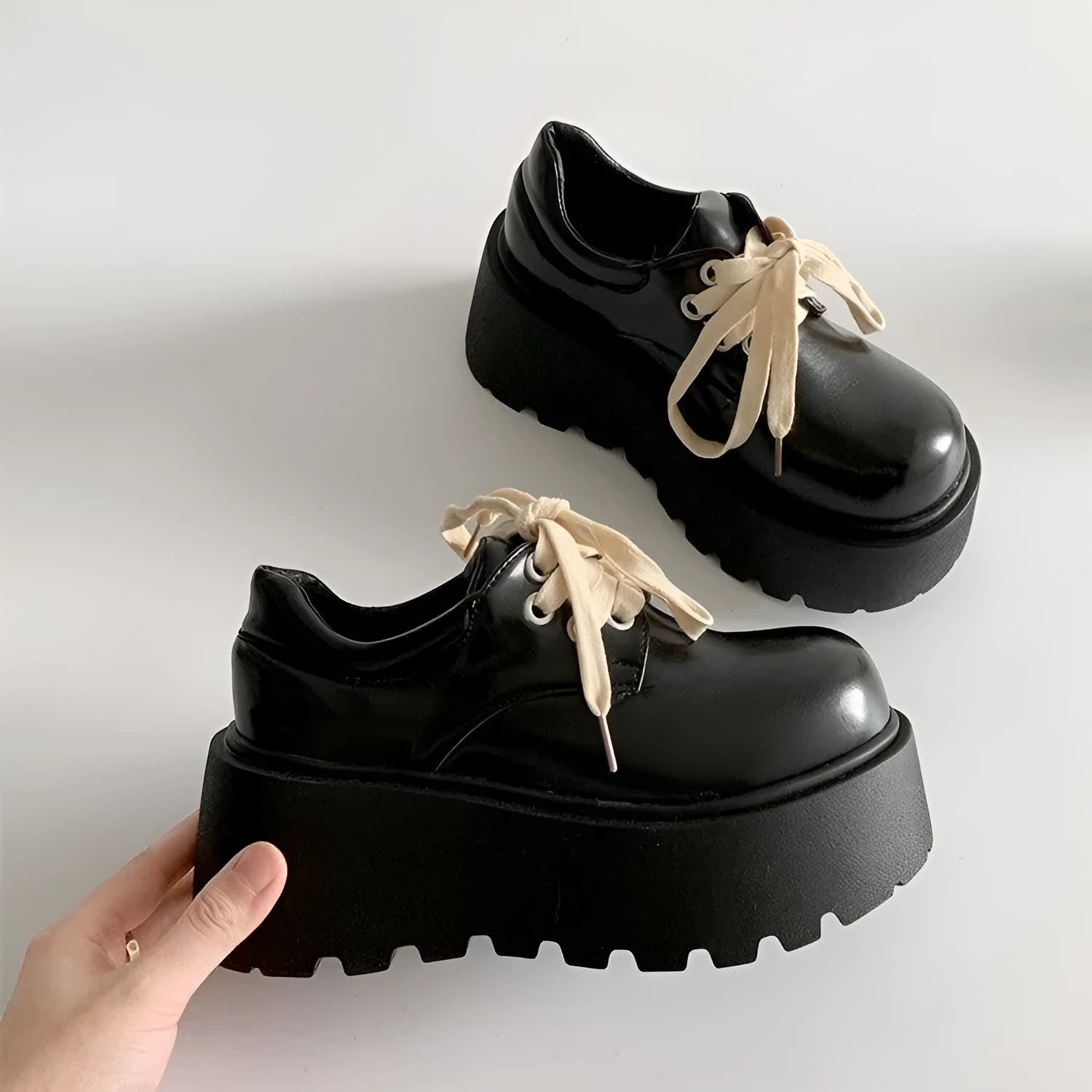 Matte black women's lace-up boots with thick rubber sole and English muffin heel