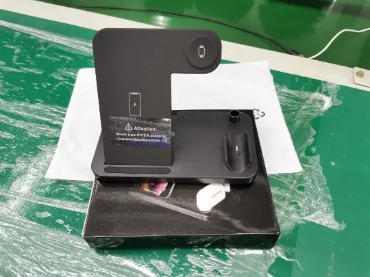 Folding 4-in-1 wireless charger in stand mode charging an iPhone and Apple Pencil.
