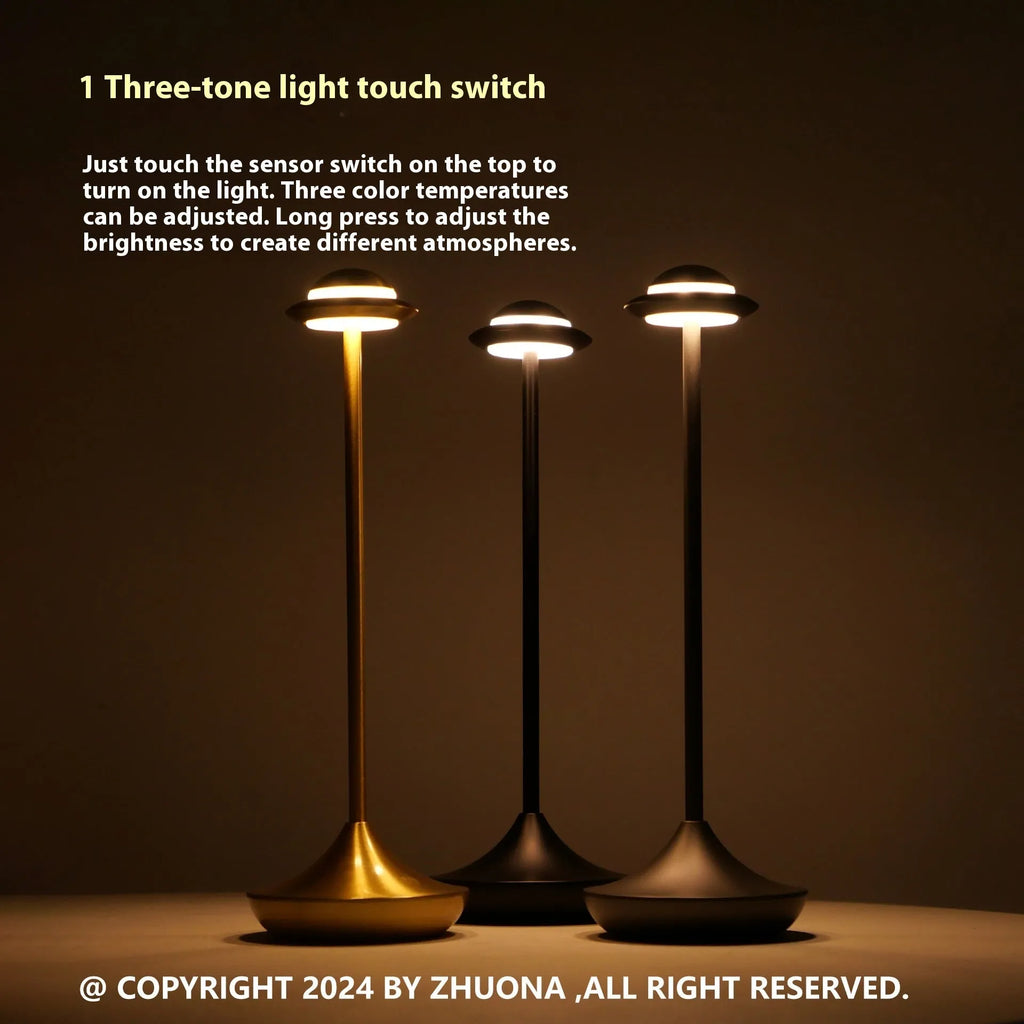 Modern metal UFO-shaped desk lamp in black on a wooden table, showing touch controls.