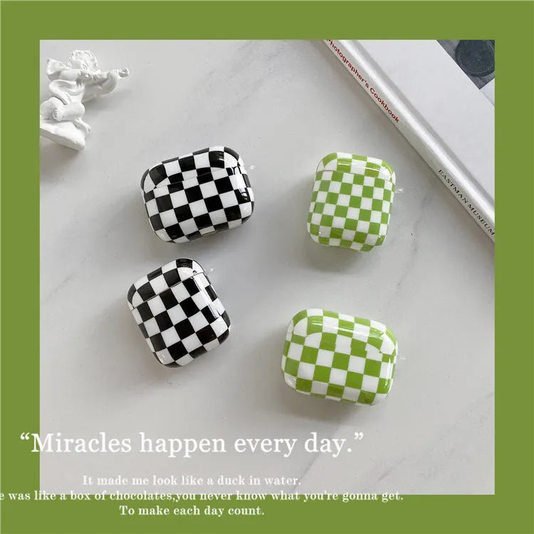 Black and green checkerboard pattern TPU protective case covers for Apple AirPods, one with a smiley face lanyard.