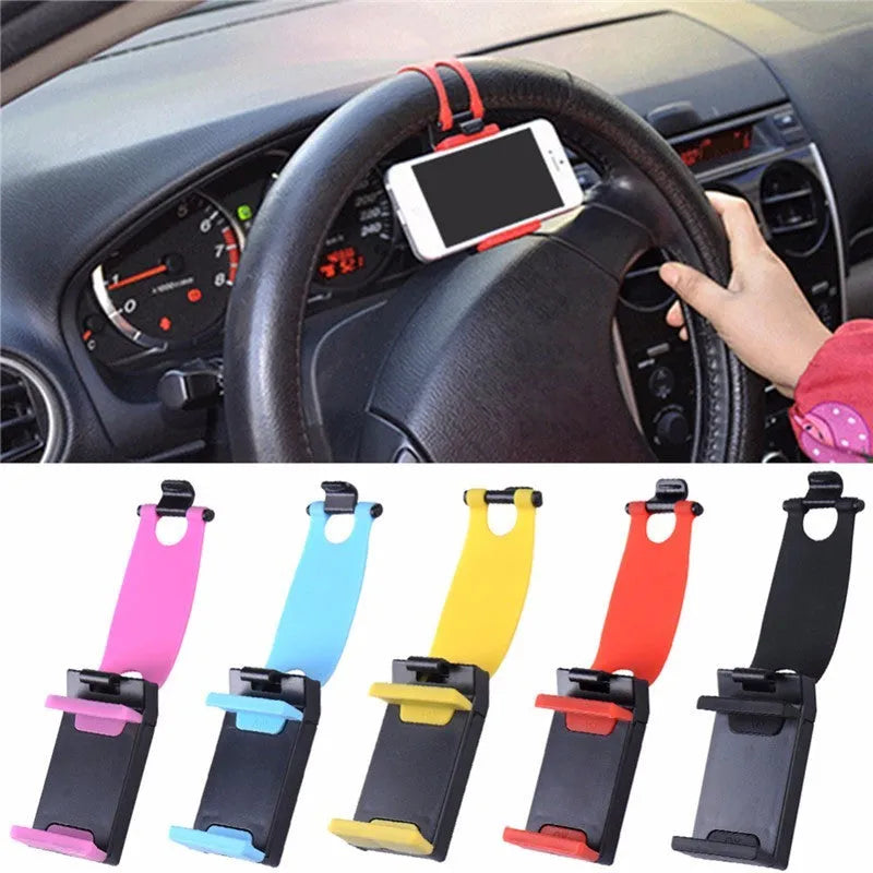 Black universal steering wheel phone holder clip mounted on a car steering wheel holding a smartphone.