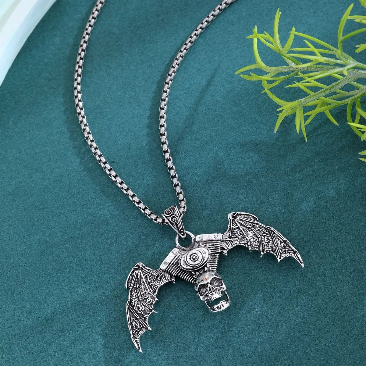 Gothic dark skull alloy necklace with skeleton wing pendant on display