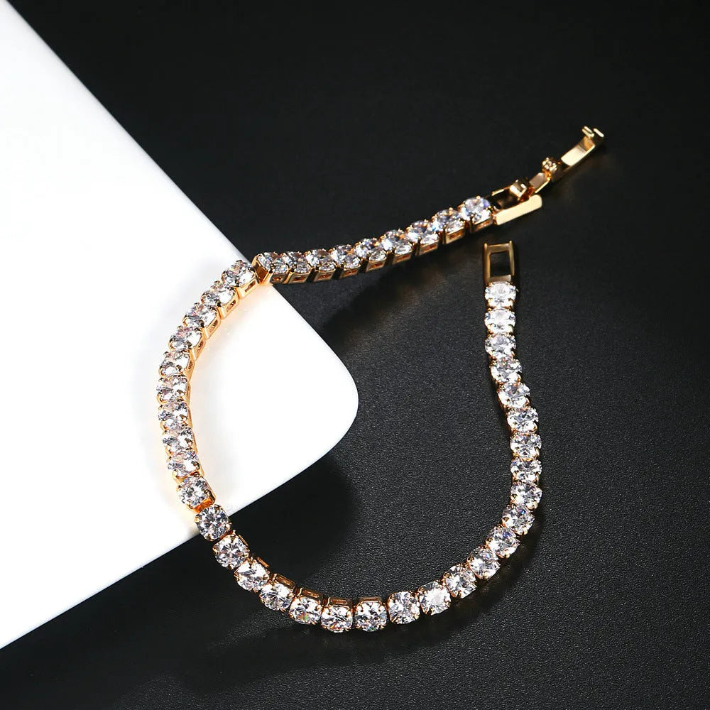 Stainless steel zircon bracelet single row 4mm round full diamond tennis chain in gold finish on white background