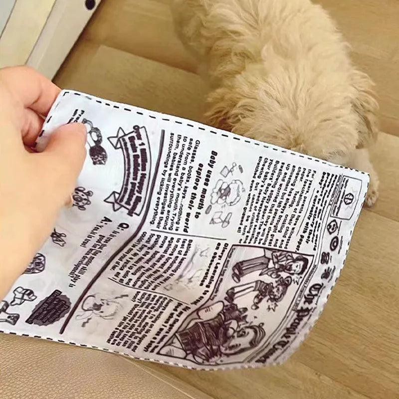 Tearproof rubber dog toy with playing card designs J, K, Q and newspaper motif with squeaking sound feature