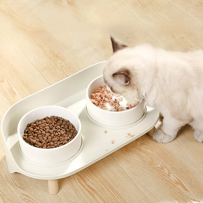 Green adjustable tilted double pet bowl for cats and dogs, showing separate food and water compartments.