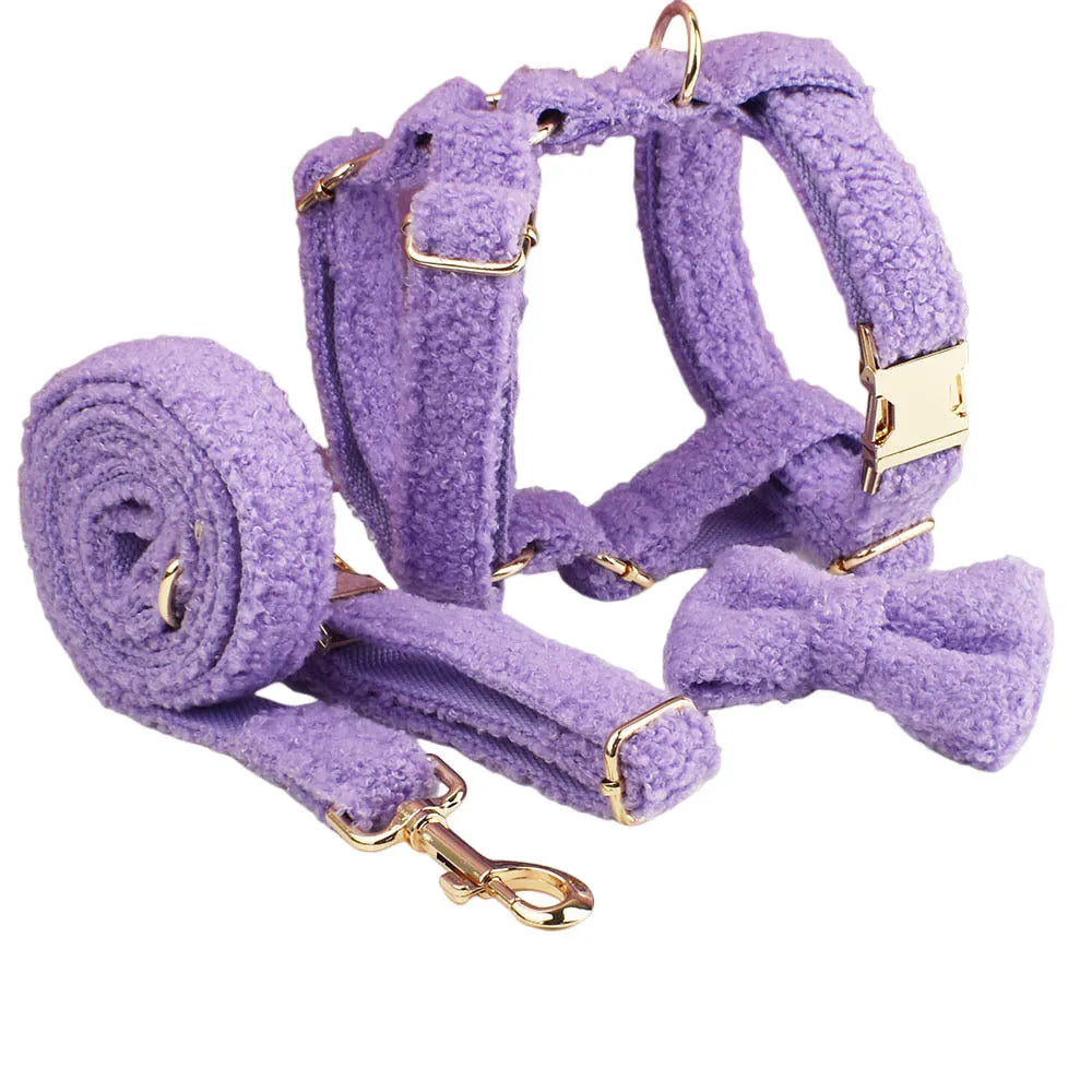 Purple cloth dog collar, leash, vest and bow four-piece pet accessory set showing coordinated design