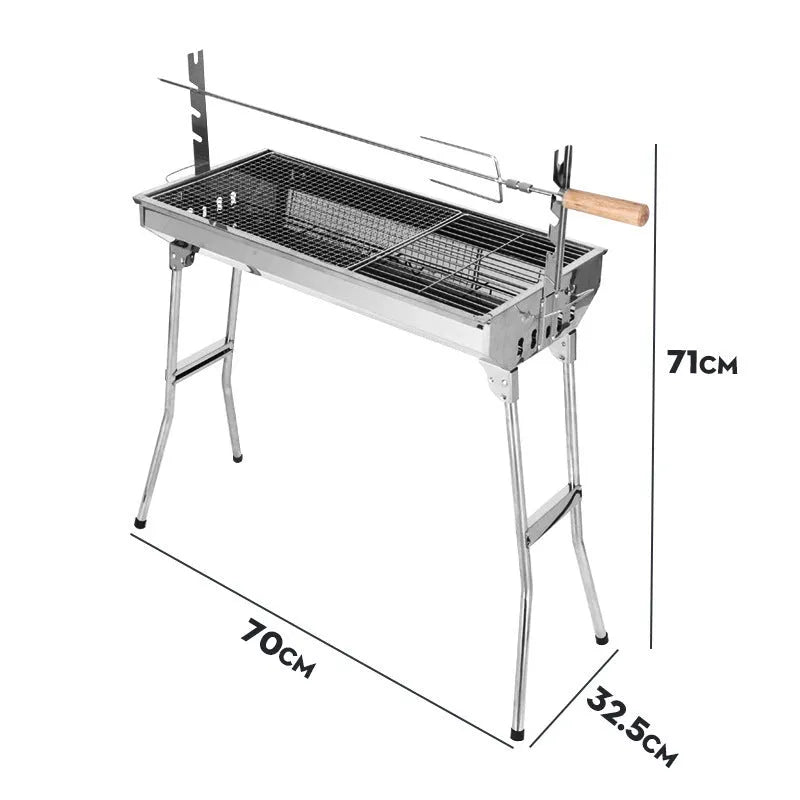 Large stainless steel turnover barbecue oven with charcoal grill and cooking accessories.