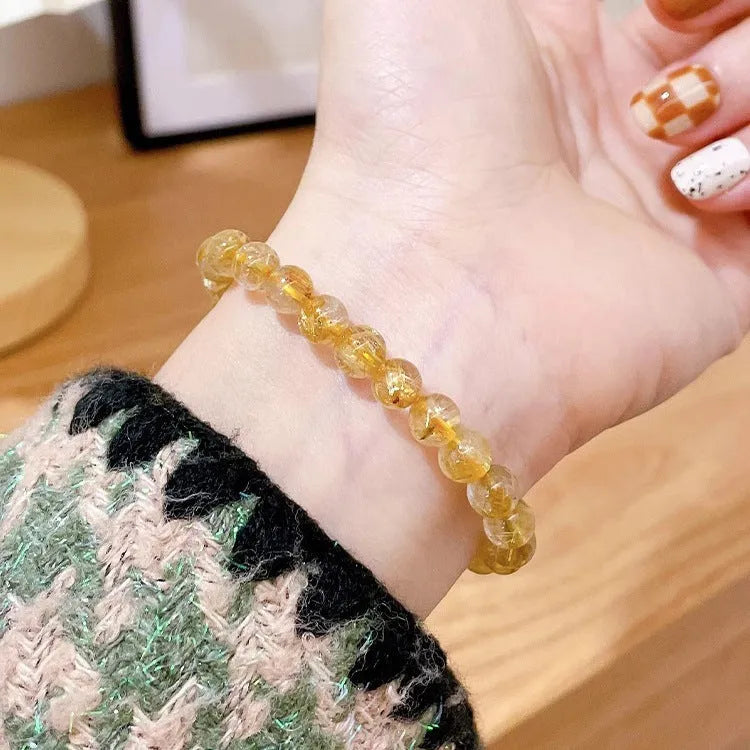 Gold rutilated quartz sunstone crystal bracelet with round diamond-shaped beads