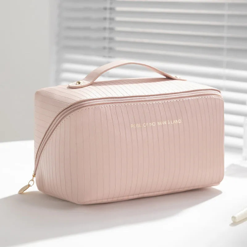 Vertical pattern cubic PU leather makeup bag in beige, shown open to display large capacity interior.