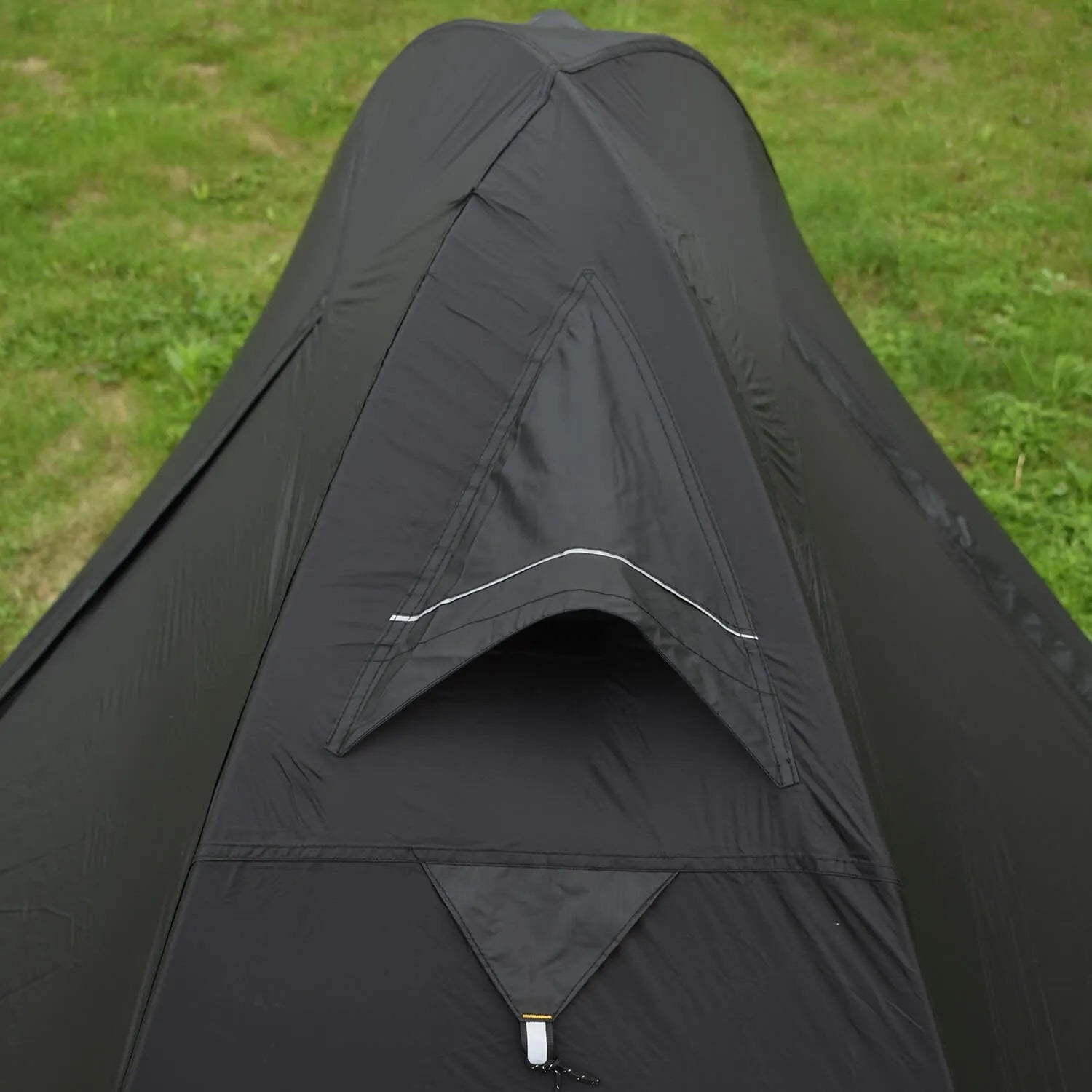 Single person camping tent with aluminium poles shown in black colour with waterproof outer layer and mesh ventilation panels