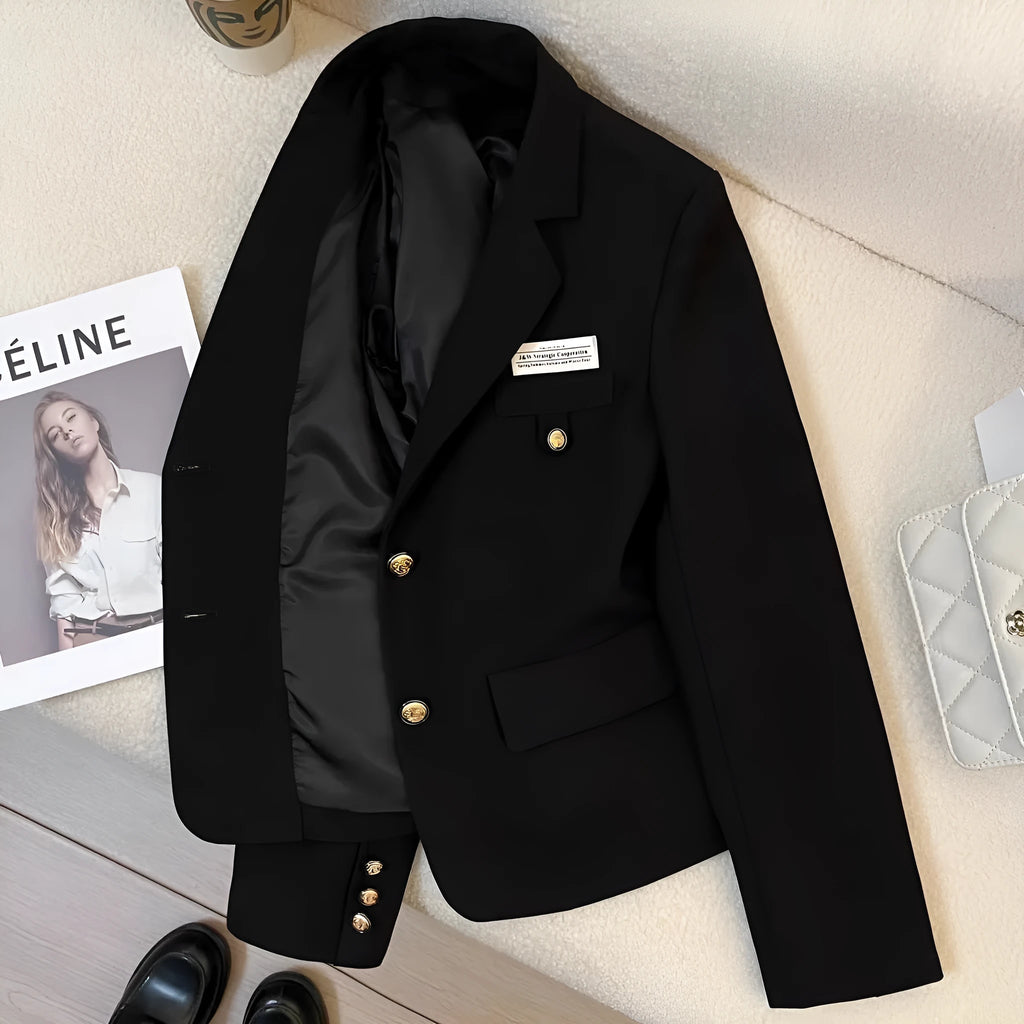 Women's black short suit coat with loose fit and regular sleeves on hanger
