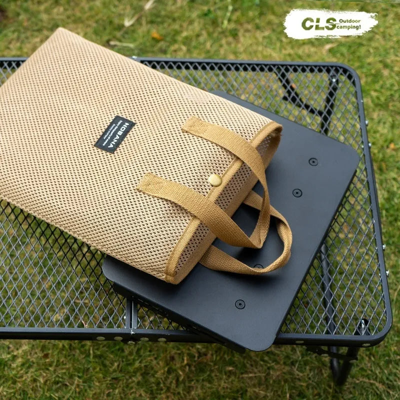 Aluminium alloy dual-use folding camping stool and table with green cushion.