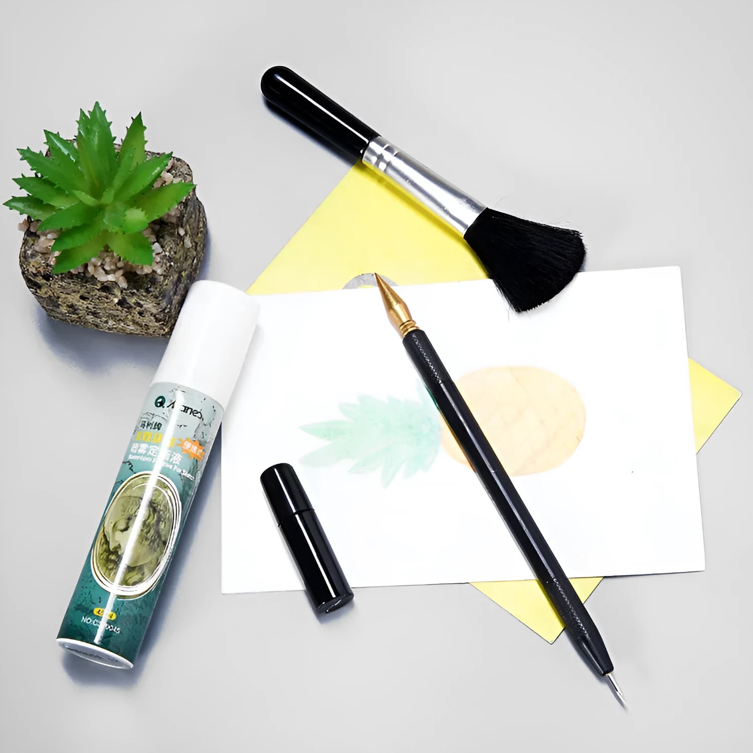 Scratch art tool kit with scraping pens, brushes, repair liquid, and bamboo sticks on a craft table.