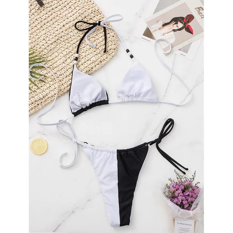 Black and white women's bikini set with lace-up front on triangle cup top and high-waist briefs.