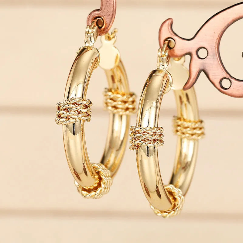 Women's copper geometric earrings with ring and line design elements in gold colours