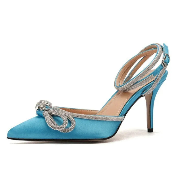 Women's black stiletto heel sandals with a silk back bandage and buckle fastening, shown from the side.