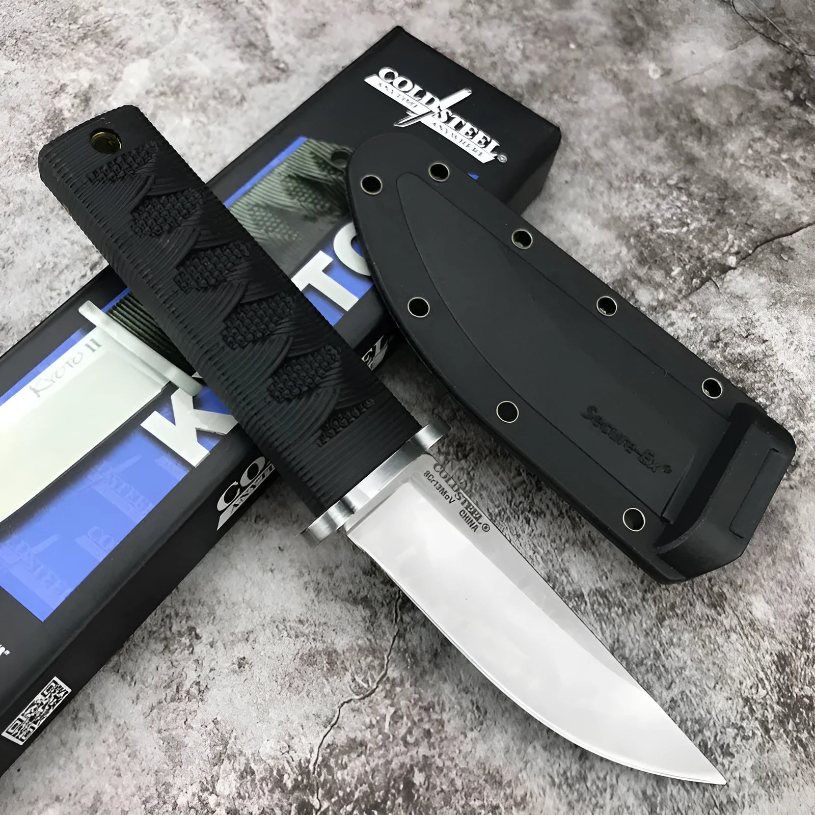 Mini fixed blade knife with 440C steel blade and ABS handle on a wooden surface