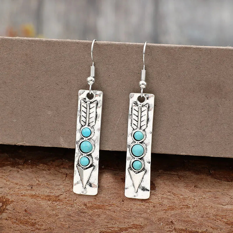 Long geometric silver earrings with turquoise inlay detail, retro style women's jewellery