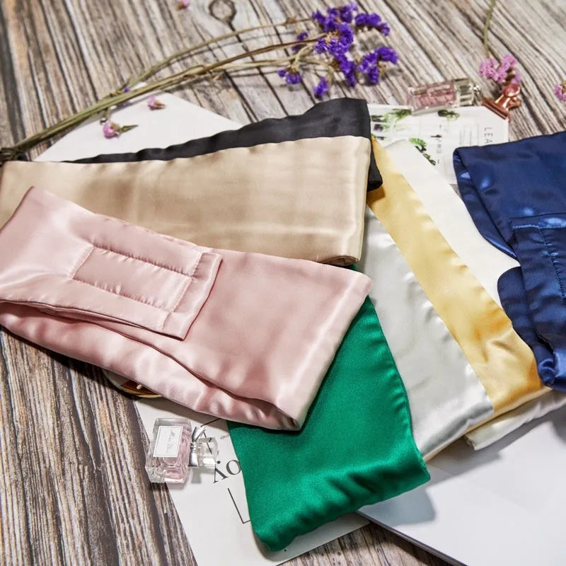 Mulberry silk sleep eye mask shown in multiple colours including black, champagne gold, navy blue, and pink.