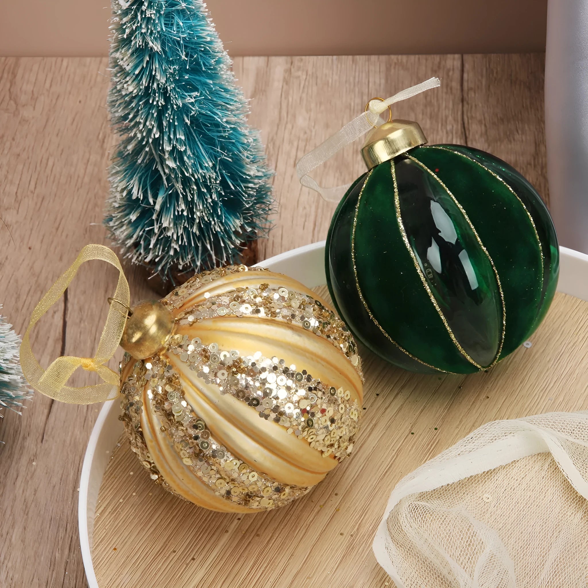 Green and yellow striped flocking Christmas glass ball decoration with mosaic surface on white background