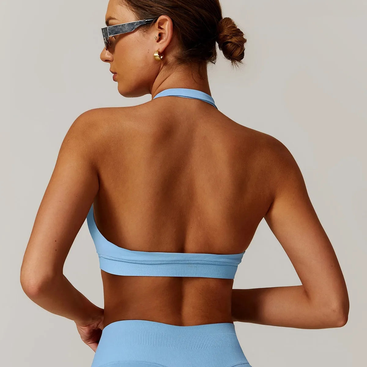 Halter neck sports bra for women in nylon, shown in plum purple colour.