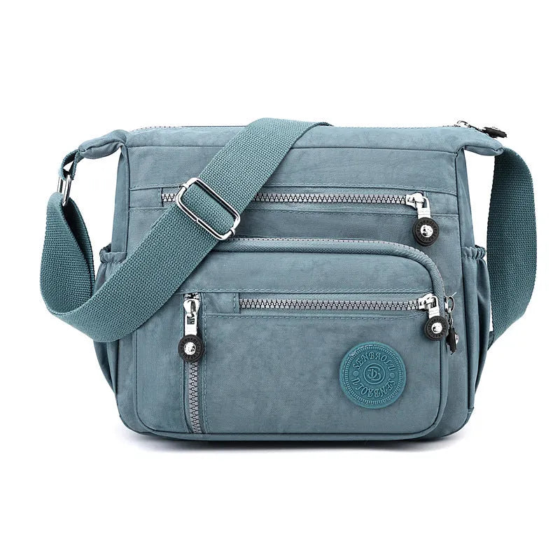 Grey nylon messenger bag with single shoulder strap showing square vertical shape