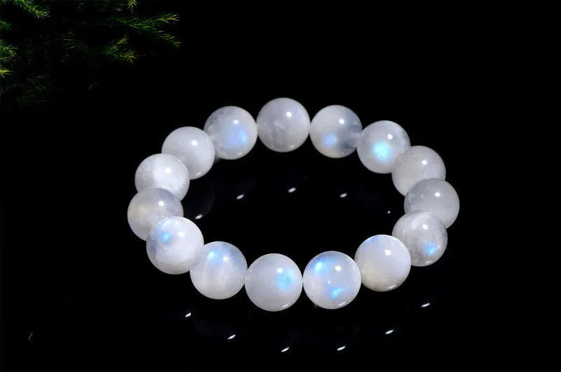 Polished moonstone bracelet with round blue beads showing natural colour variations