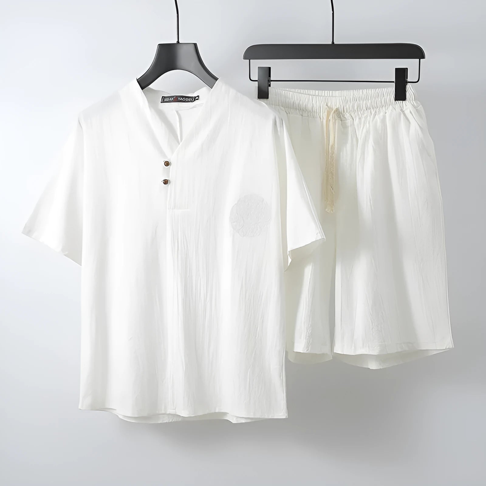 Men's loose fit apricot-coloured linen-style cotton short sleeve top and shorts two-piece set laid flat.