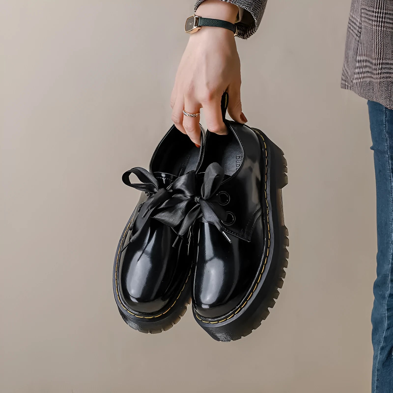 Women's black thick soled leather shoes with cross straps and lace-up closure