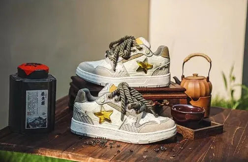 Green low-top casual shoes with star pattern and lace-up closure on a rubber sole.