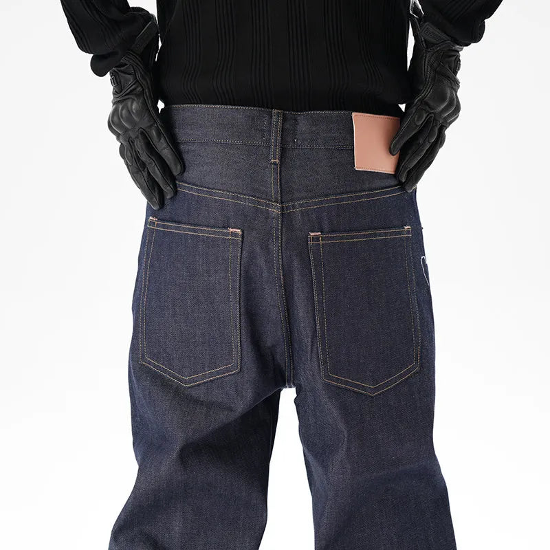 Man wearing dark blue loose straight-leg casual jeans.