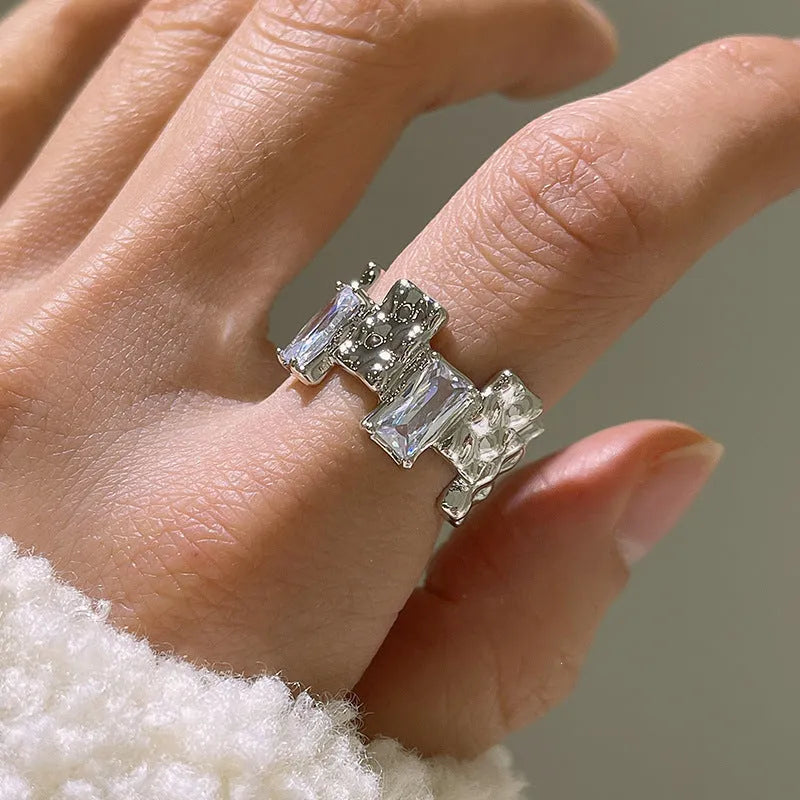 Silver geometric open ring with cross design and zircon centrepiece
