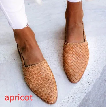 Flat pointed toe sandals with a silver buckle on a microfiber upper.