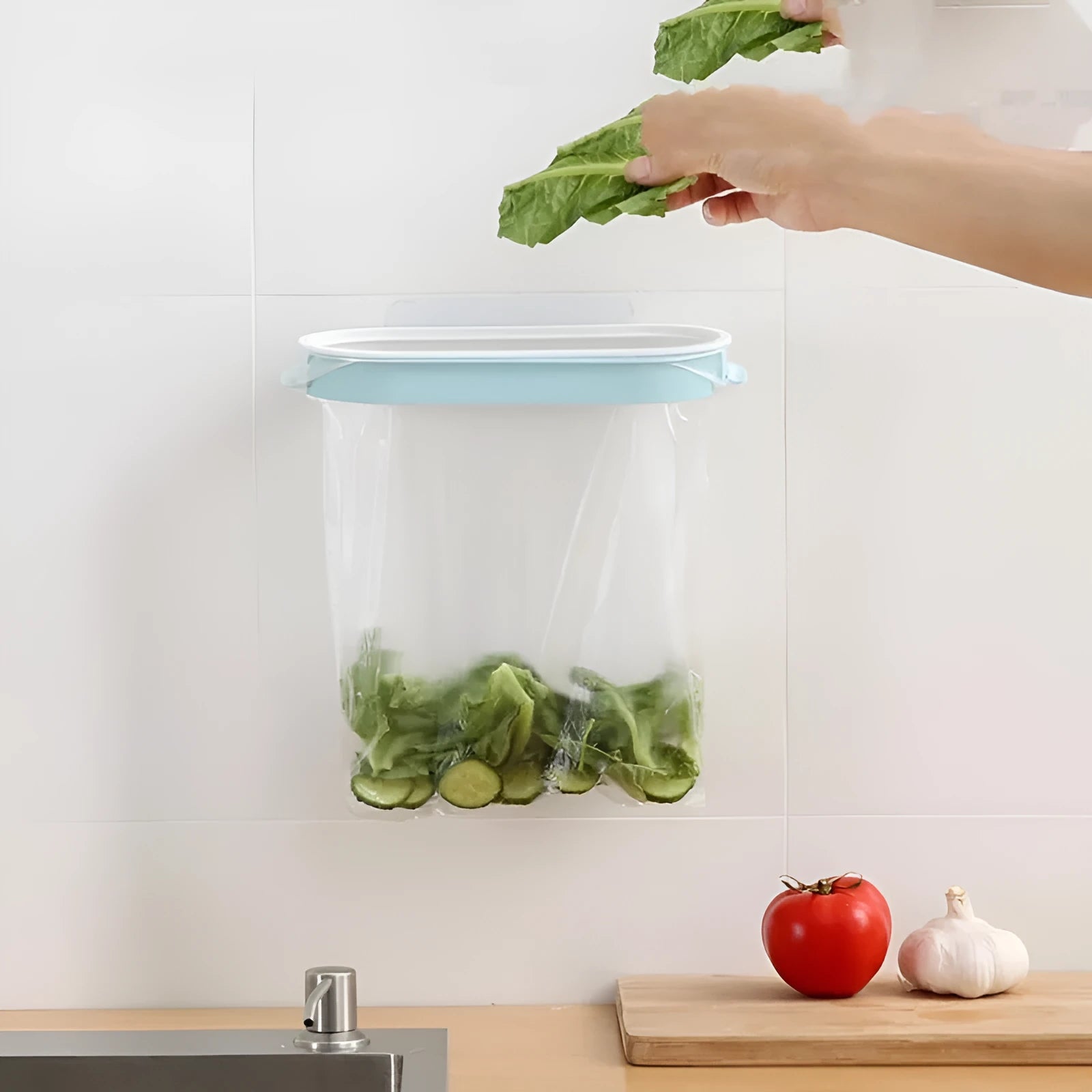 Blue plastic T-shaped garbage bag storage rack on a kitchen counter.